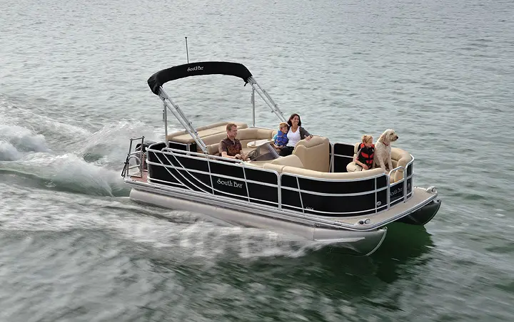 A boat with four people on it in the water.