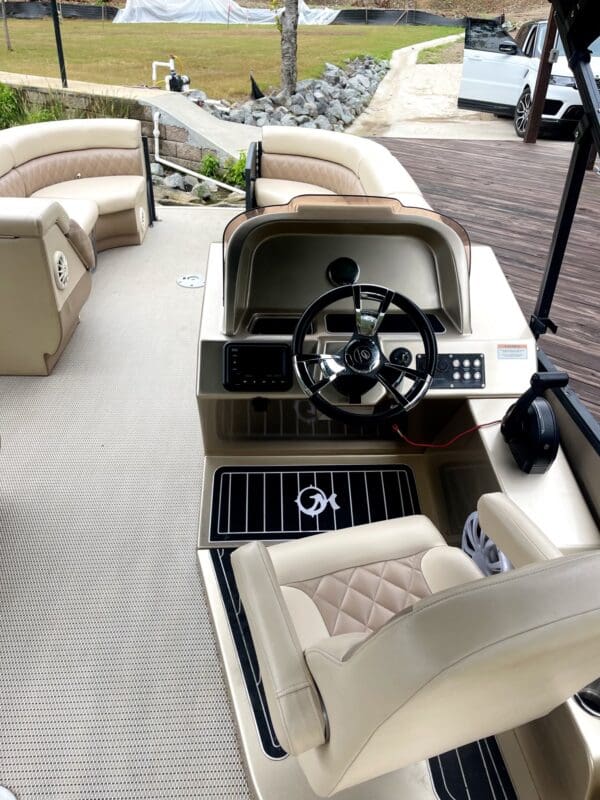 Boat interior with steering wheel and seats.