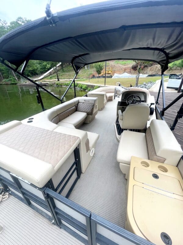 Pontoon boat interior with seating and canopy.