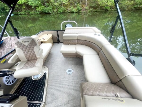 Pontoon boat interior with tan upholstery.