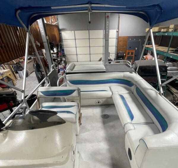 White pontoon boat with blue accents.