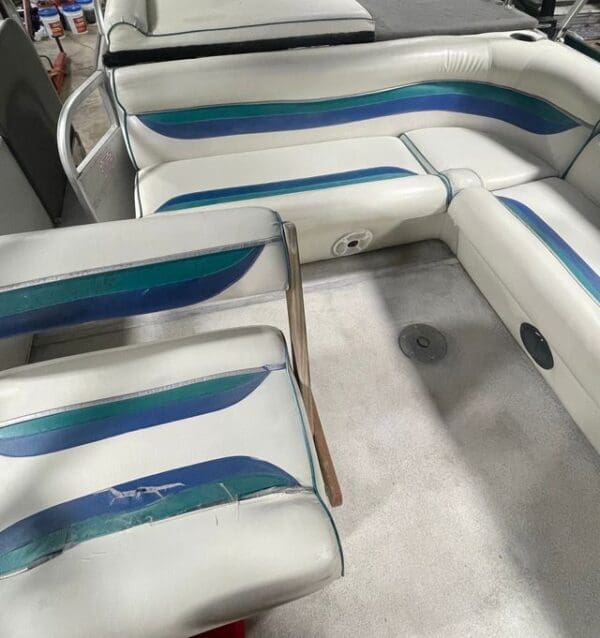 White boat seats with green and blue stripes.