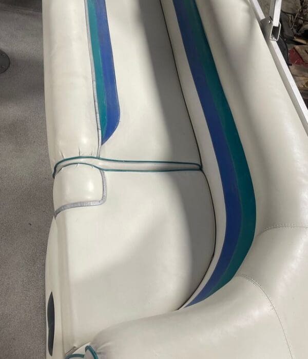 White boat seat with blue and green trim.