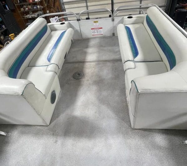 White pontoon boat with blue trim.