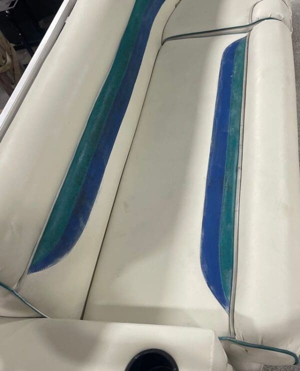 White boat seat with blue and green stripes.