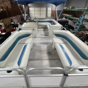 White pontoon boat with blue trim.