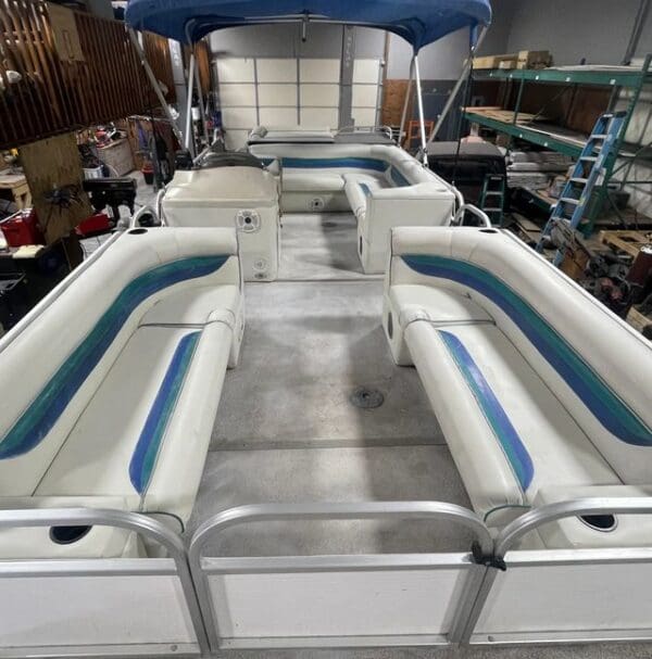 White pontoon boat with blue trim.